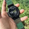 Army Green HEMSUT nylon QuickFit watch band installed on a Garmin watch outdoors
