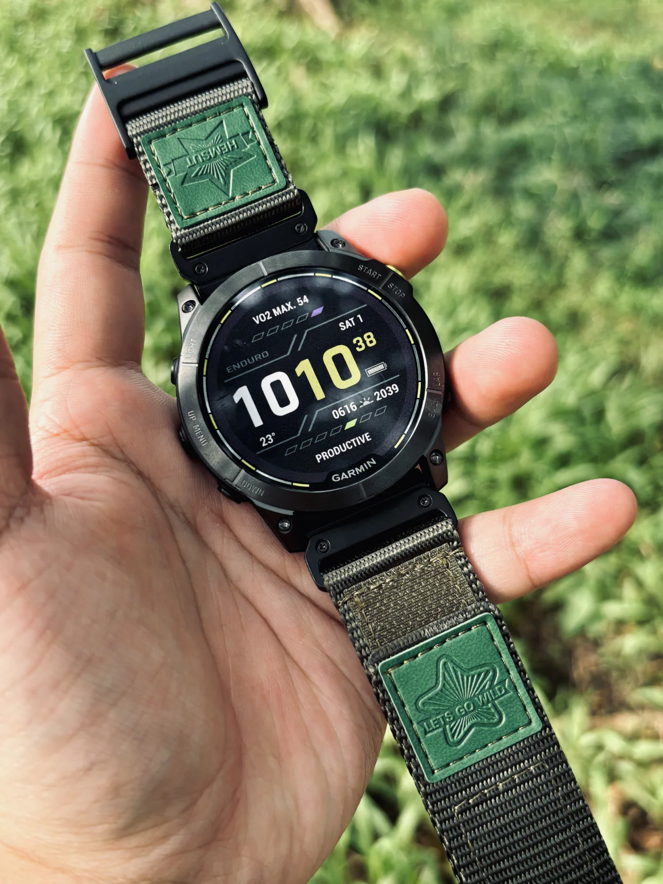 Army Green HEMSUT nylon QuickFit watch band installed on a Garmin watch outdoors