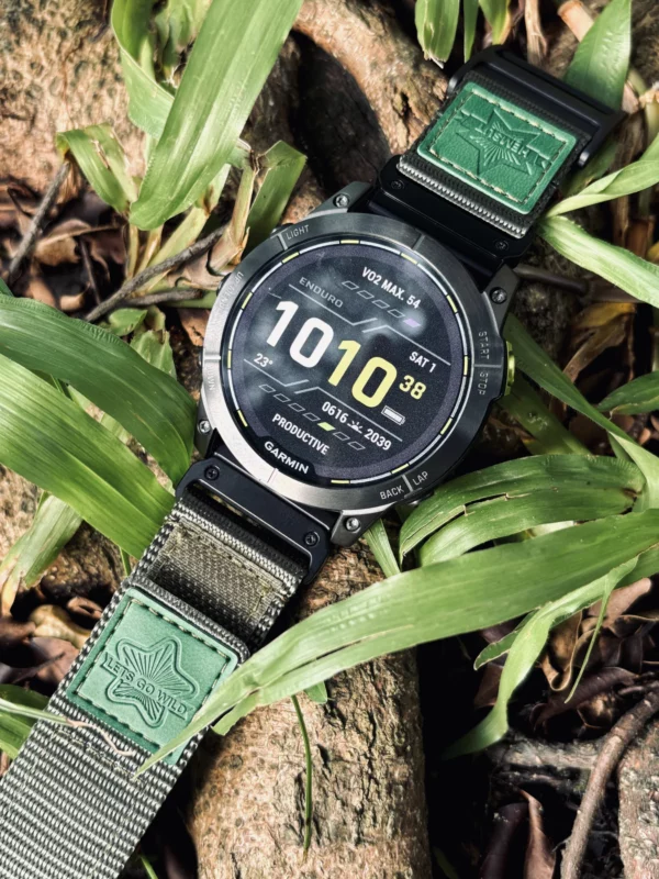Army Green nylon QuickFit watch band and Garmin watch among green leaves