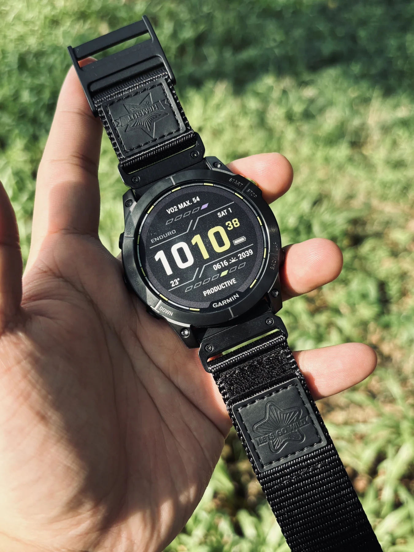 Black HEMSUT nylon QuickFit watch band installed on a Garmin watch outdoors