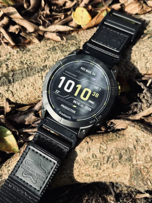 Black nylon QuickFit watch band and Garmin watch resting on a rock outdoors
