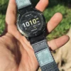 Grey HEMSUT nylon QuickFit watch band installed on a Garmin watch outdoors