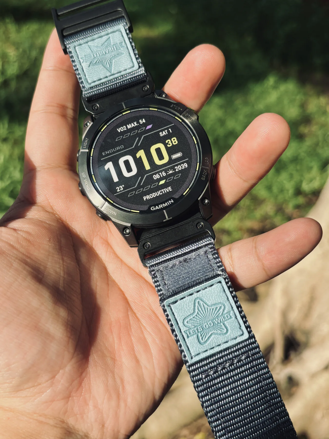 Grey HEMSUT nylon QuickFit watch band installed on a Garmin watch outdoors