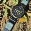 Grey nylon QuickFit watch band and Garmin watch displayed among leaves