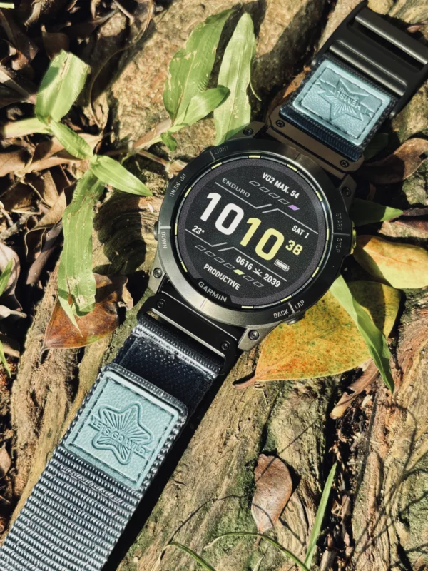 Grey nylon QuickFit watch band and Garmin watch displayed among leaves
