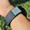 Grey nylon QuickFit watch band wrapped around a wrist outdoors