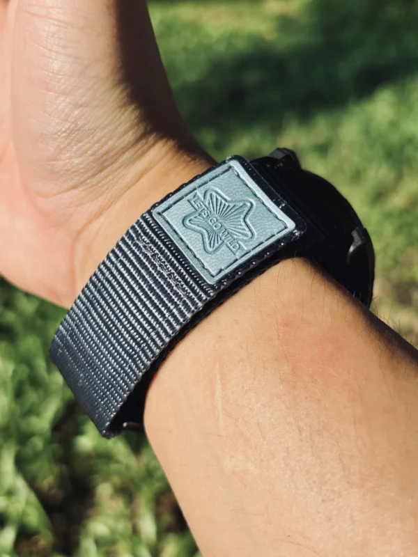 Grey nylon QuickFit watch band wrapped around a wrist outdoors
