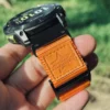 Close view of the orange nylon loop closure and black QuickFit connector