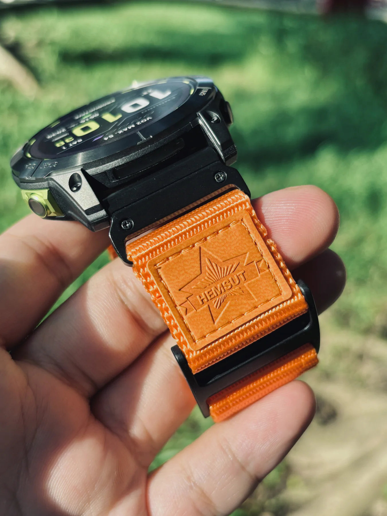 Close view of the orange nylon loop closure and black QuickFit connector