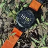 Orange nylon QuickFit watch band and Garmin watch displayed on outdoor ground