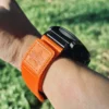 Orange nylon QuickFit watch band shown from the side on a wrist