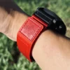 Red nylon QuickFit watch band shown from the side on a wrist