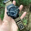 hg155-gwg2000-coyote-01-hand-front Coyote HEMSUT nylon hook-and-loop watch band fitted to a G-SHOCK GWG-2000, held outdoors