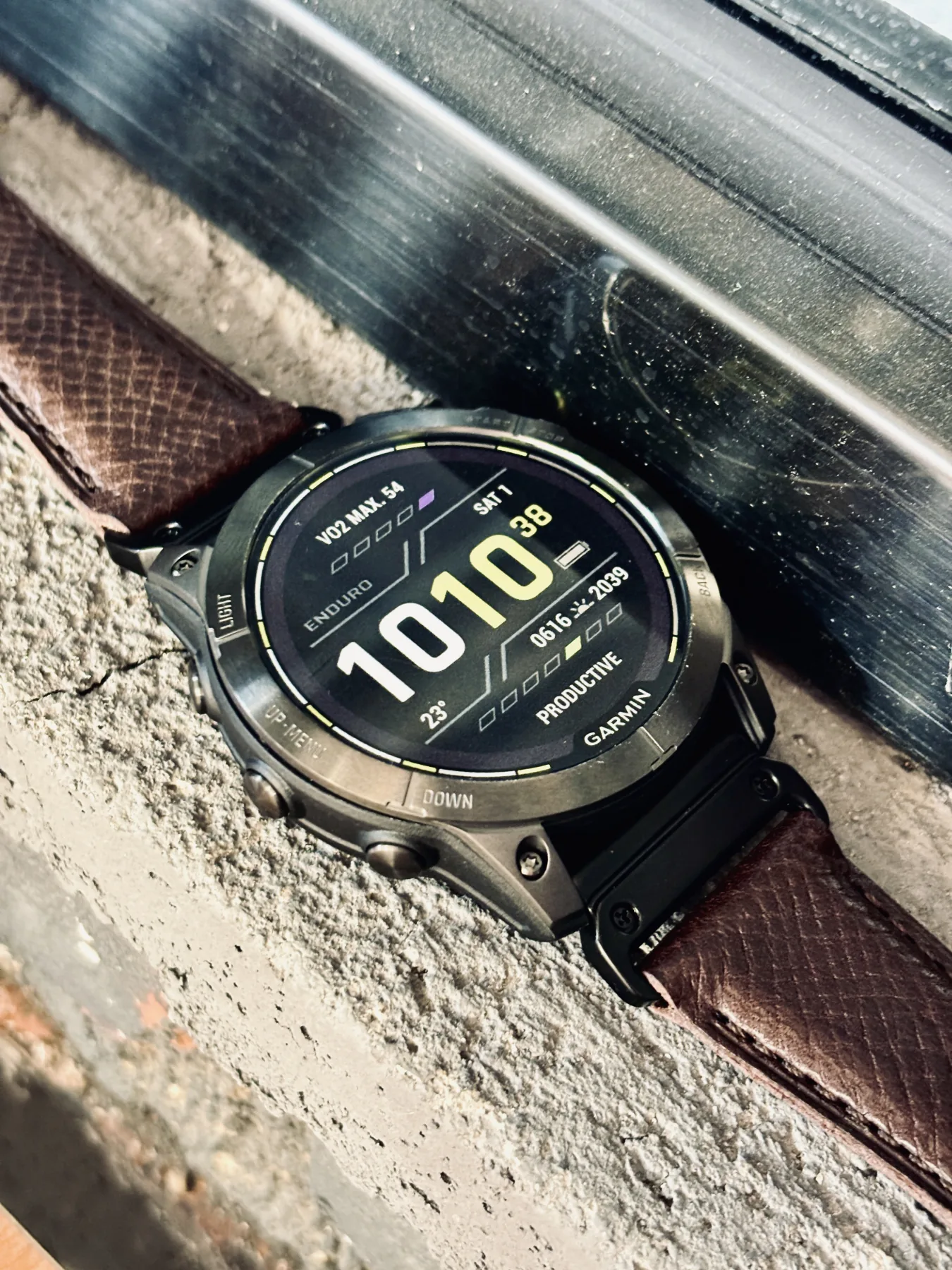 Garmin watch with Burgundy Italian leather strap placed outdoors on stone