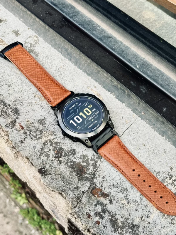 hga160-garmin-badalassi-carlo-cognac-brown-outdoor-flat-lay Garmin watch with Cognac Brown Badalassi Carlo strap placed outdoors on stone